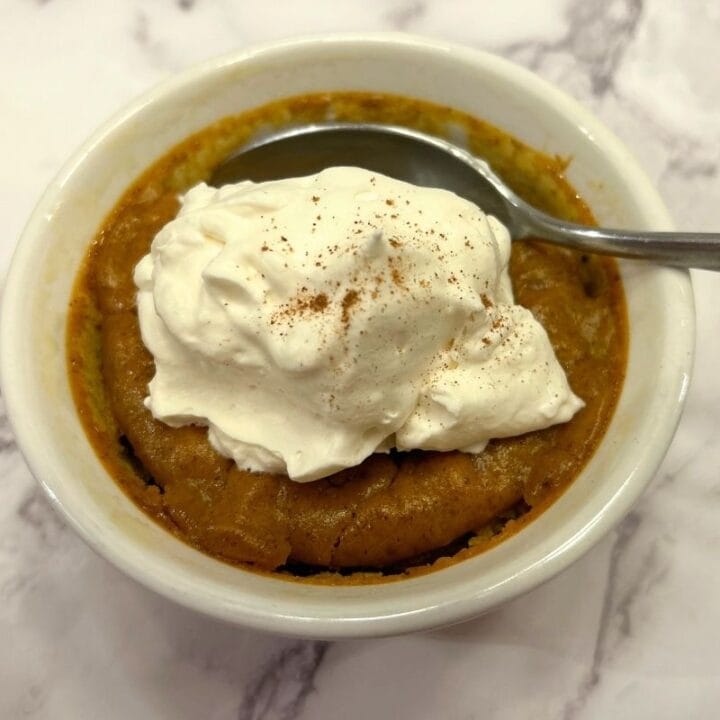 a spoon in a bowl of maple pumpkin custard