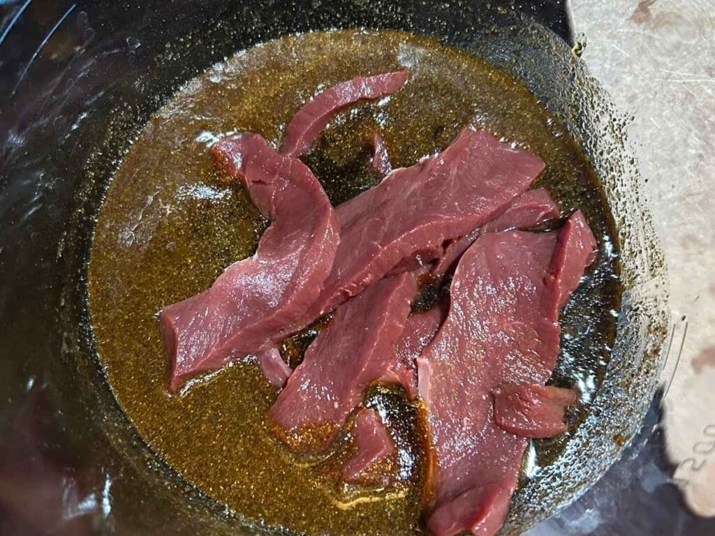beef heart slices in marinade