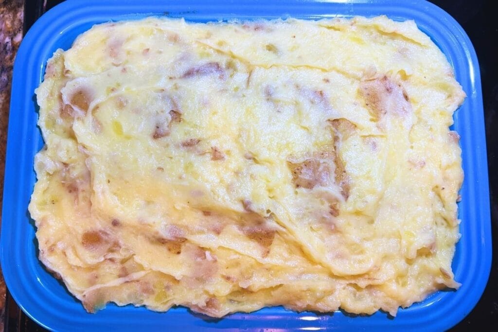 mashed potatoes in blue casserole dish