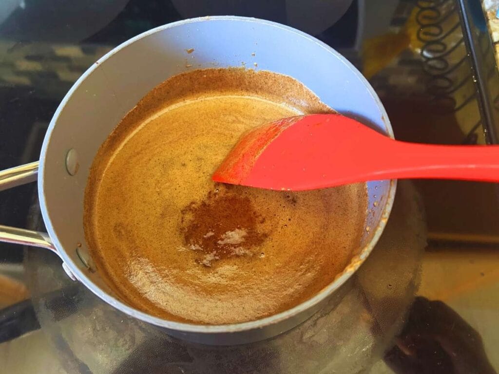 simmering spiced maple syrup in a pot