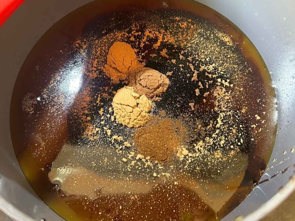 spices in maple syrup in a saucepan
