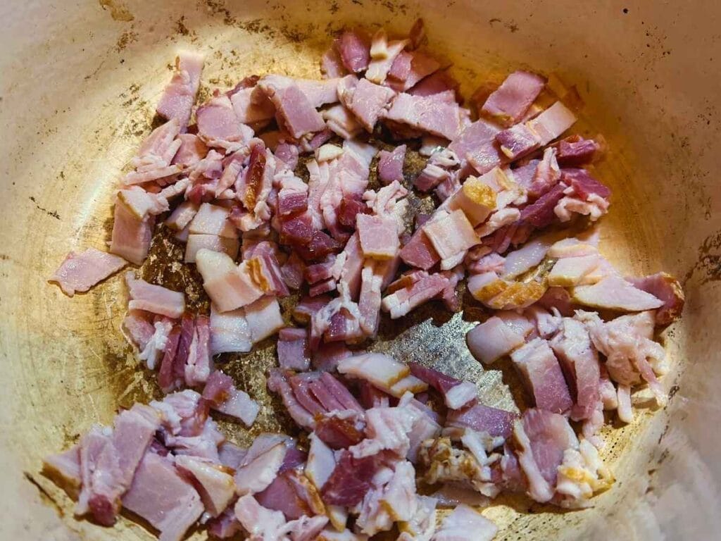 chopped bacon cooking in a dutch oven