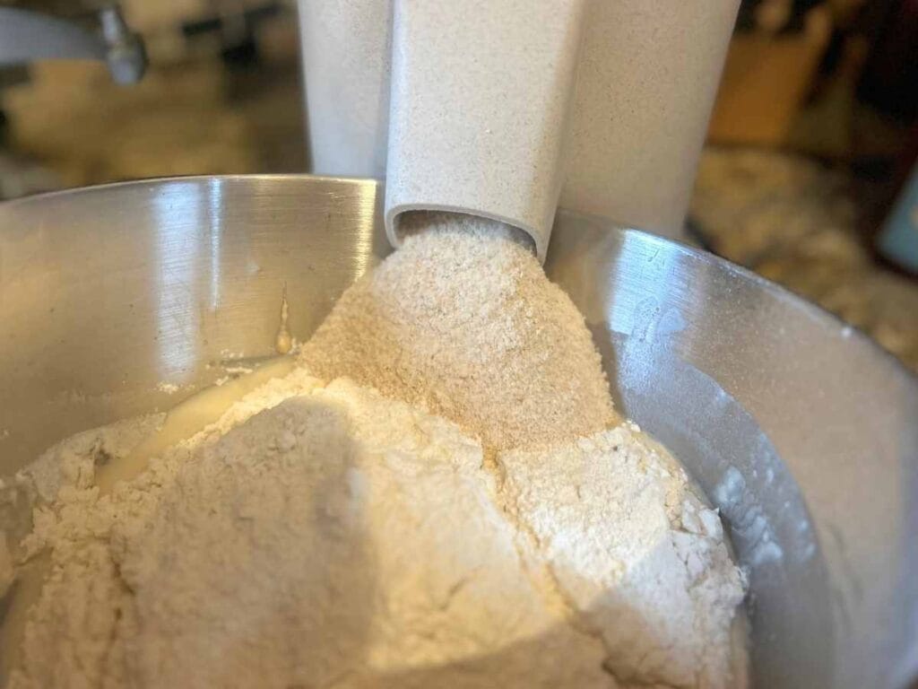 milling flour into bowl full of all purpose flour