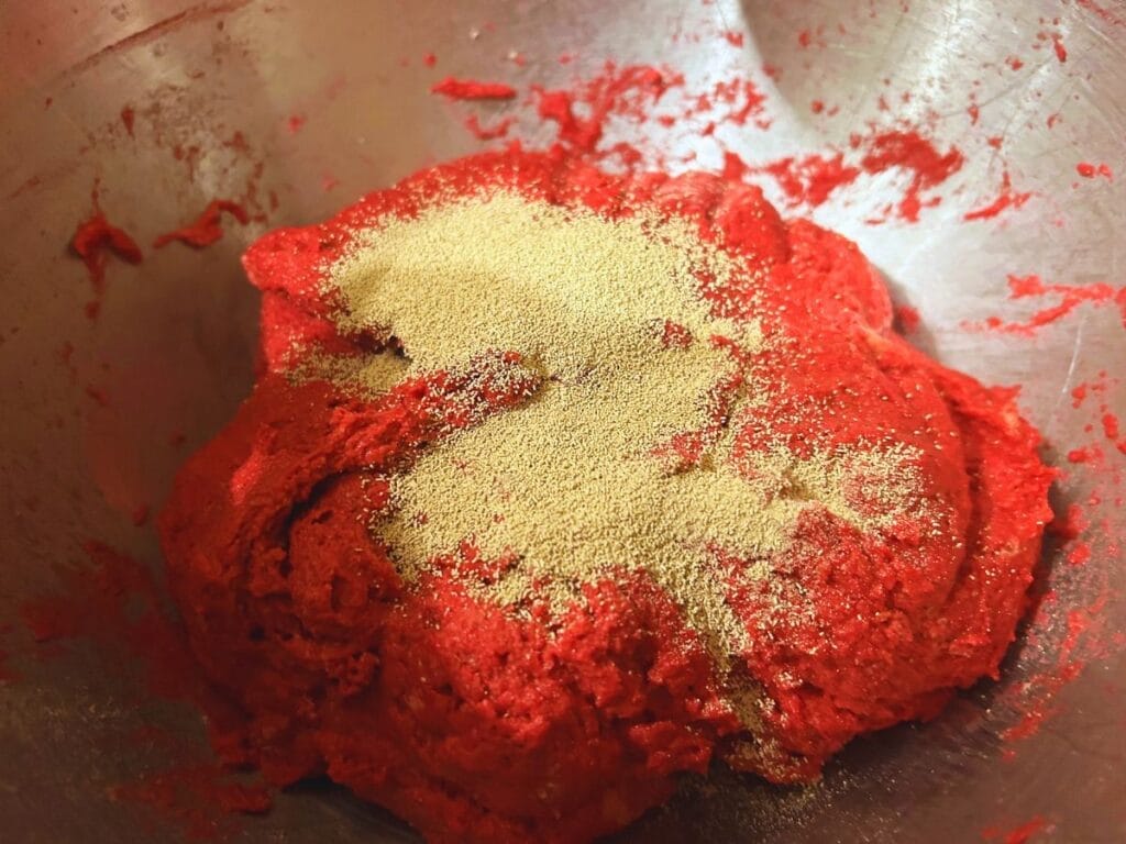yeast sprinkled over pink dough