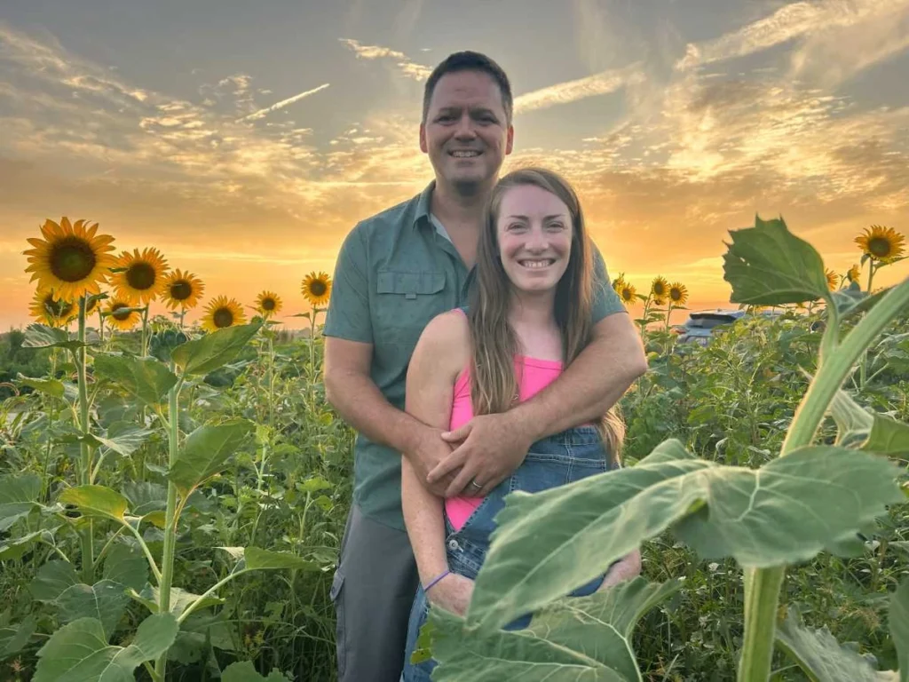 man and woman in sunflower field
