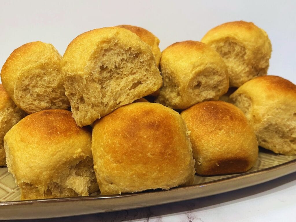 homemade Hawaiian rolls stacked up on a serving plate