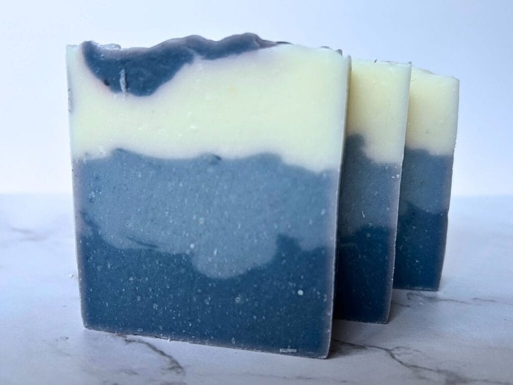 three bars of three layer blue eucalyptus mint tallow soap arranged in a row