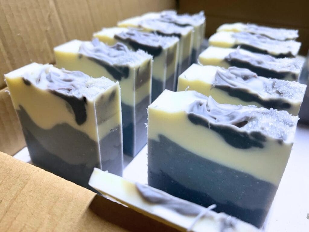 bars of three layer blue eucalyptus mint tallow soap in a carboard box to cure