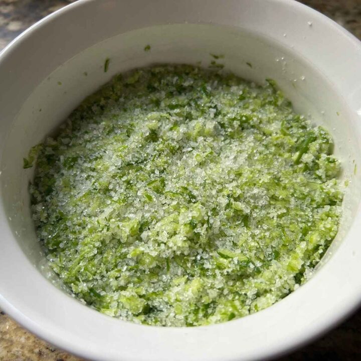 chopped garlic scapes mixed with sea salt in a ramekin