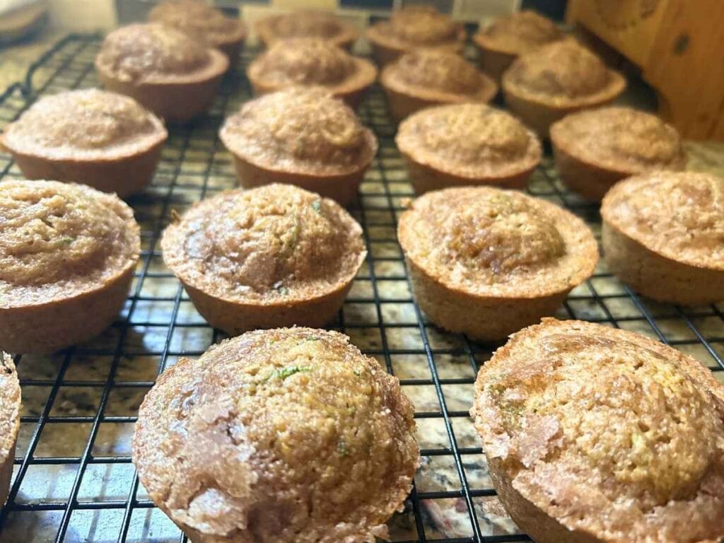 zucchini bread muffins on a wire cooling rack