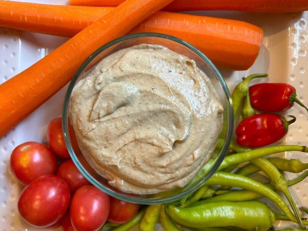bowl of baba ganoush surrounded by fresh vegetables