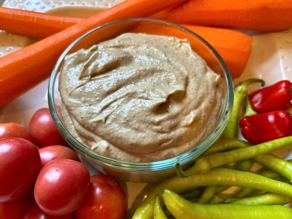 bowl of baba ganoush surrounded by fresh vegetables