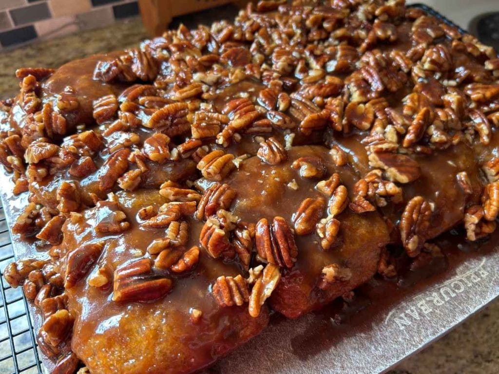 Sourdough pecan sticky buns turned out on a cutting board