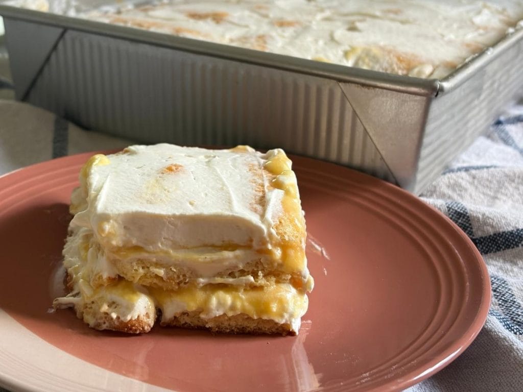 side view of a slice of peach tiramisu in front of the pan